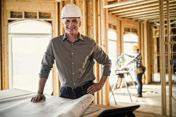 Architect looking over blueprints